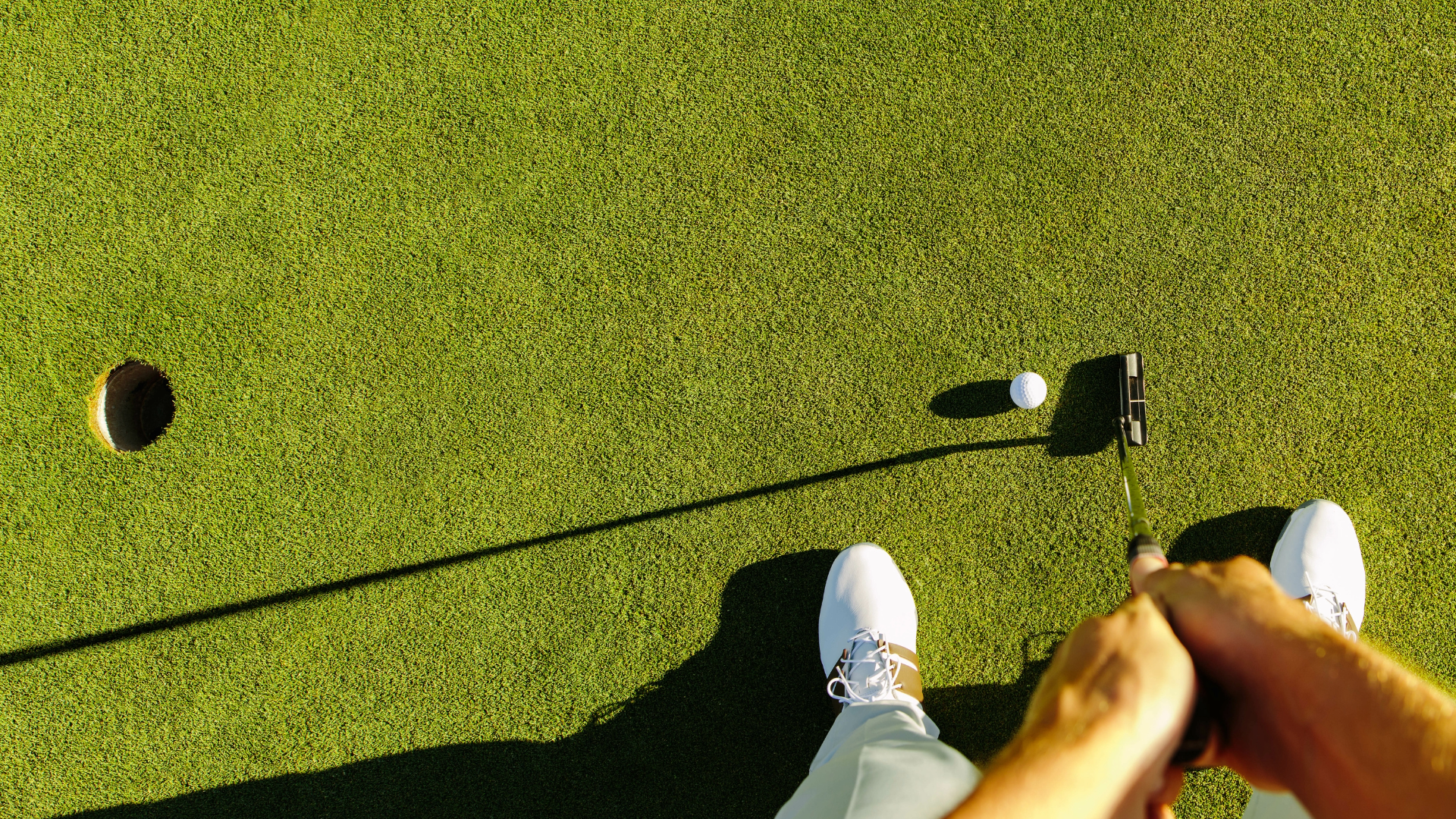 Top down view of golfer about to putt